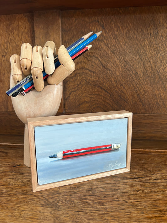 An artist hand holding pencils. 